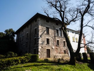 Veduta angolare del Castello di Torre che mette in evidenza il corpo più antico del Castello. Si notano le pietre e i mattoni che compongono i muri riferibili a varie fasi di intervento architettonico sull'edificio.